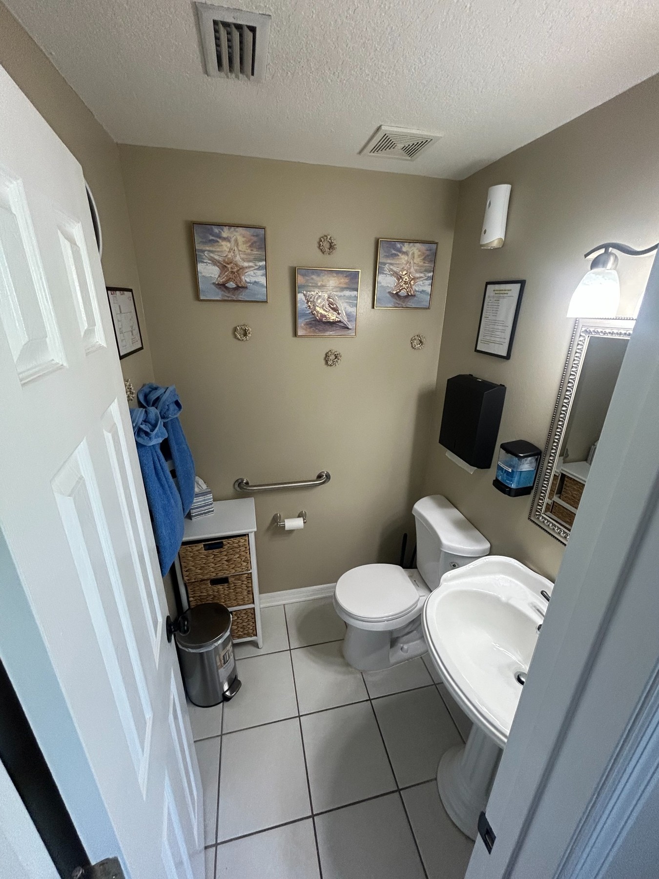 Bathroom showing a toilet, sink, and grab bars