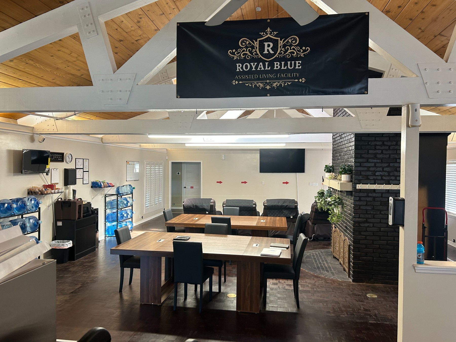 Common area with tables, seating, and a Royal Blue sign