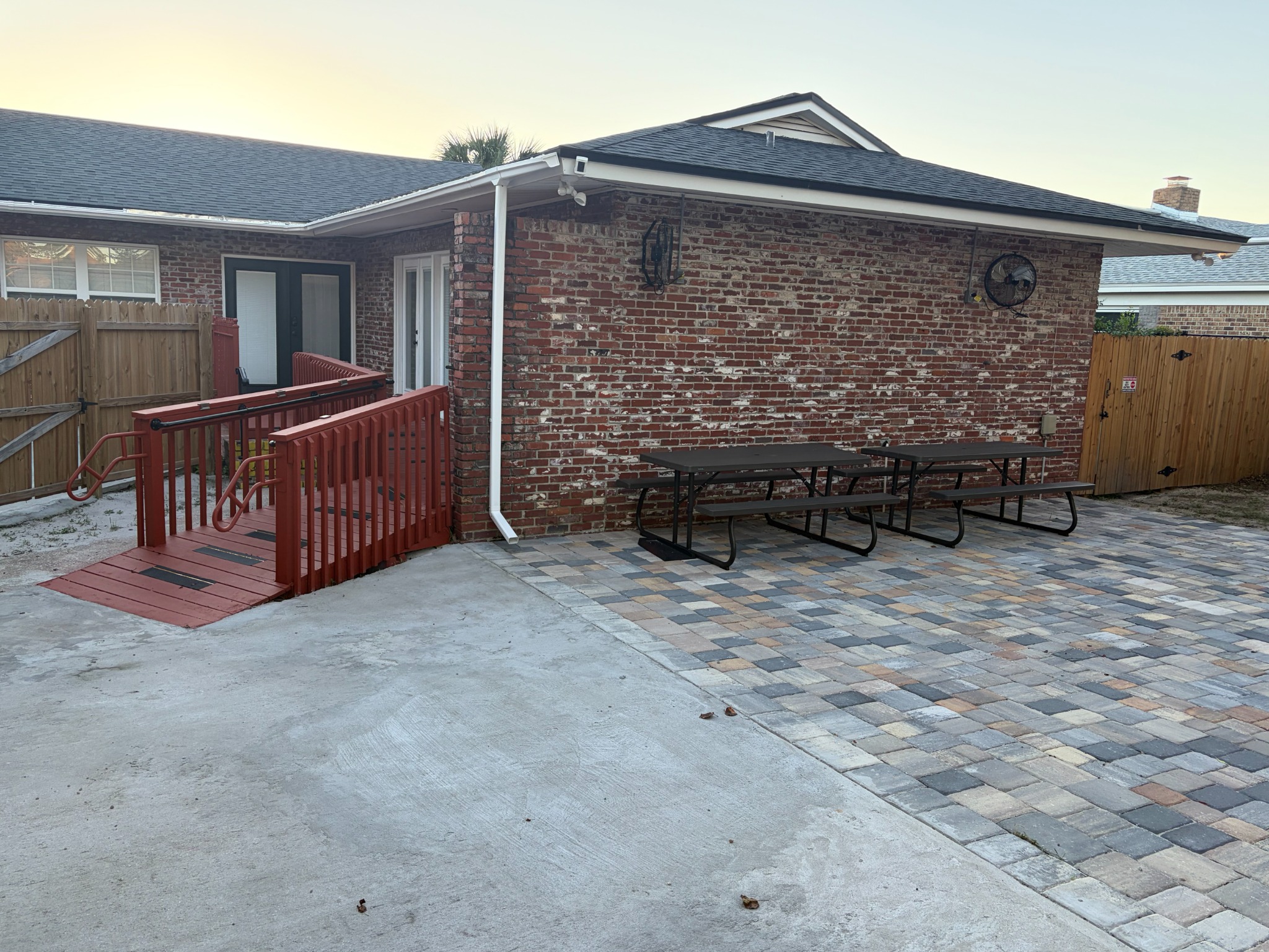 Royal Blue courtyard with picnic tables, paving, and an entrance ramp