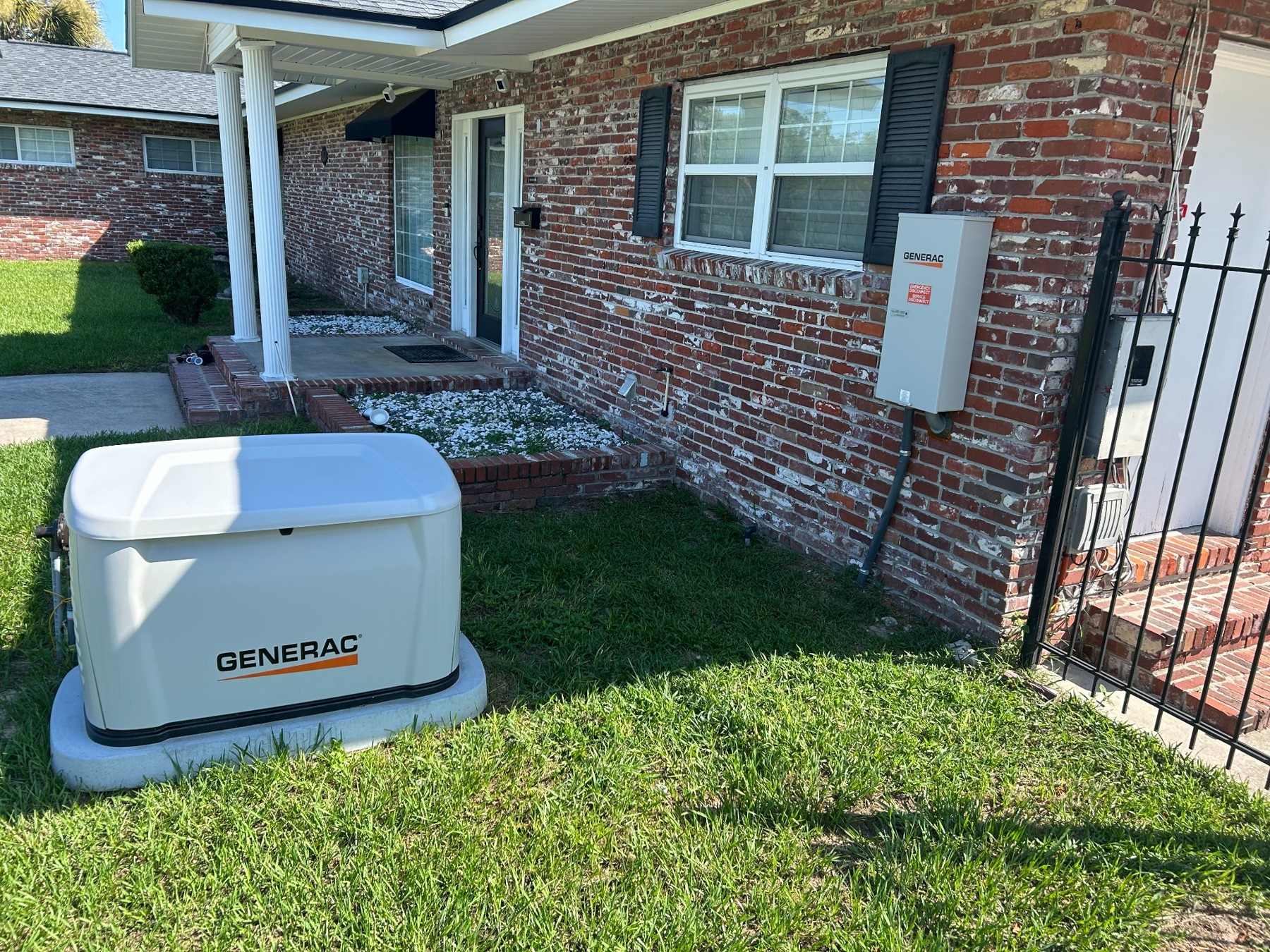 Generator beside the brick exterior of Royal Blue